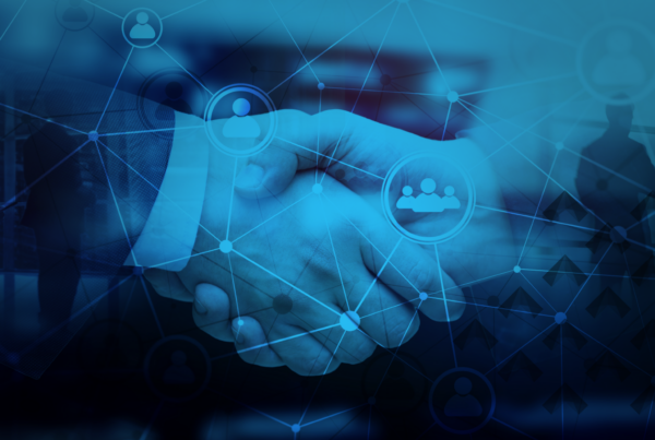 A handshake with a blue overlay including floating images of users, stakeholders, and connections for the blog titled Developing an Effective Communication Strategy for a Merger